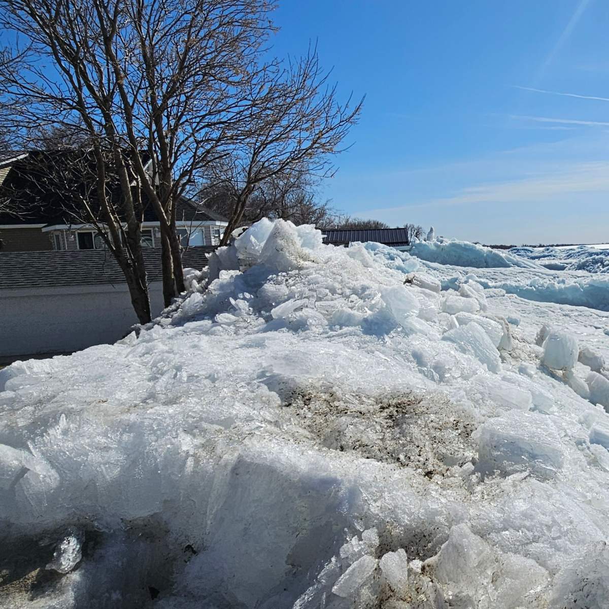 The ice wall climbs a property in the Twin Lakes Beach, Man., area.