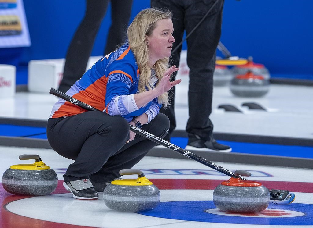 Chelsea Carey wants to be clear, she's not trying to fill Jennifer Jones' curling shoes. Carey directs her sweeper as they play Saskatchewan at the Scotties Tournament of Hearts at Fort William Gardens in Thunder Bay, Ont. on Monday, Jan. 31, 2022. THE CANADIAN PRESS/Andrew Vaughan.