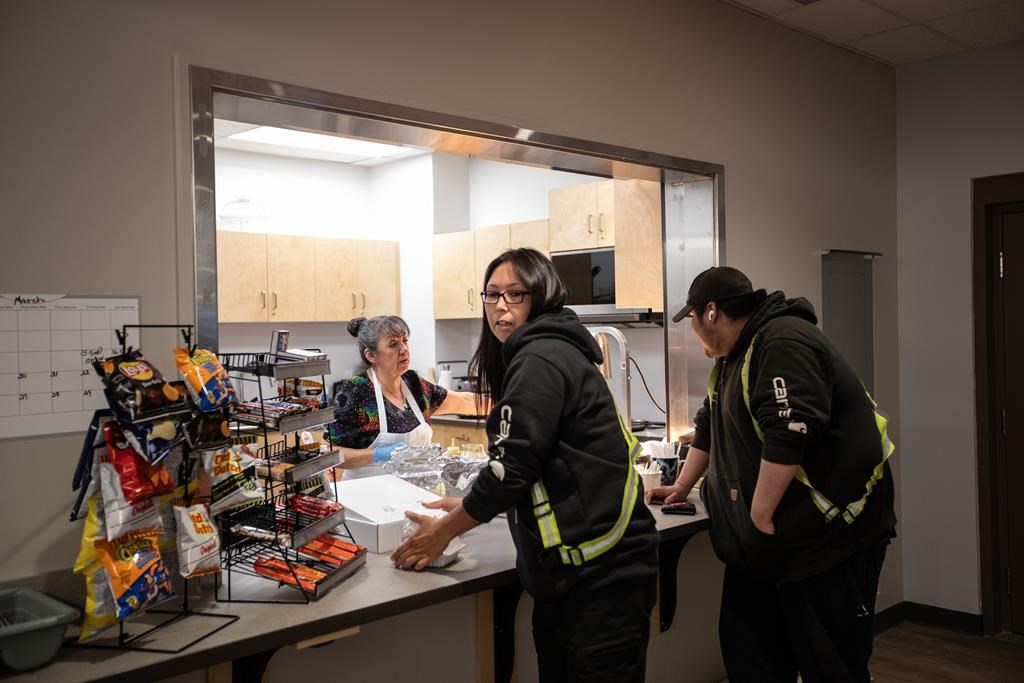 Workers stop for lunch at the arena, one of many amenities and infrastructure projects the community of 700 has been able to finance through relationship with industry, in Fort McKay, Alta., on Thursday April 25, 2024. Chief Raymond Powder says while Indigenous communities did not have a say in developing the oilsands in the first place, now that they are here he is doing his best to take advantage of opportunities for his community. 