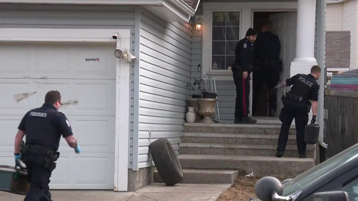 Edmonton police forensic investigators at a home near 82 Street and 11 Avenue SW in Summerside, where a child was fatally attacked by dogs on Tuesday, April 2, 2024.