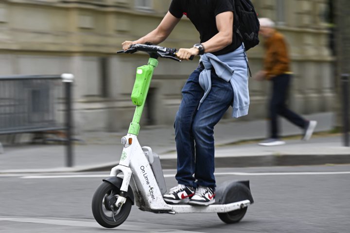 Illustration picture shows a person using a self-service electric scooters in streets of Paris, France on August 8, 2023.