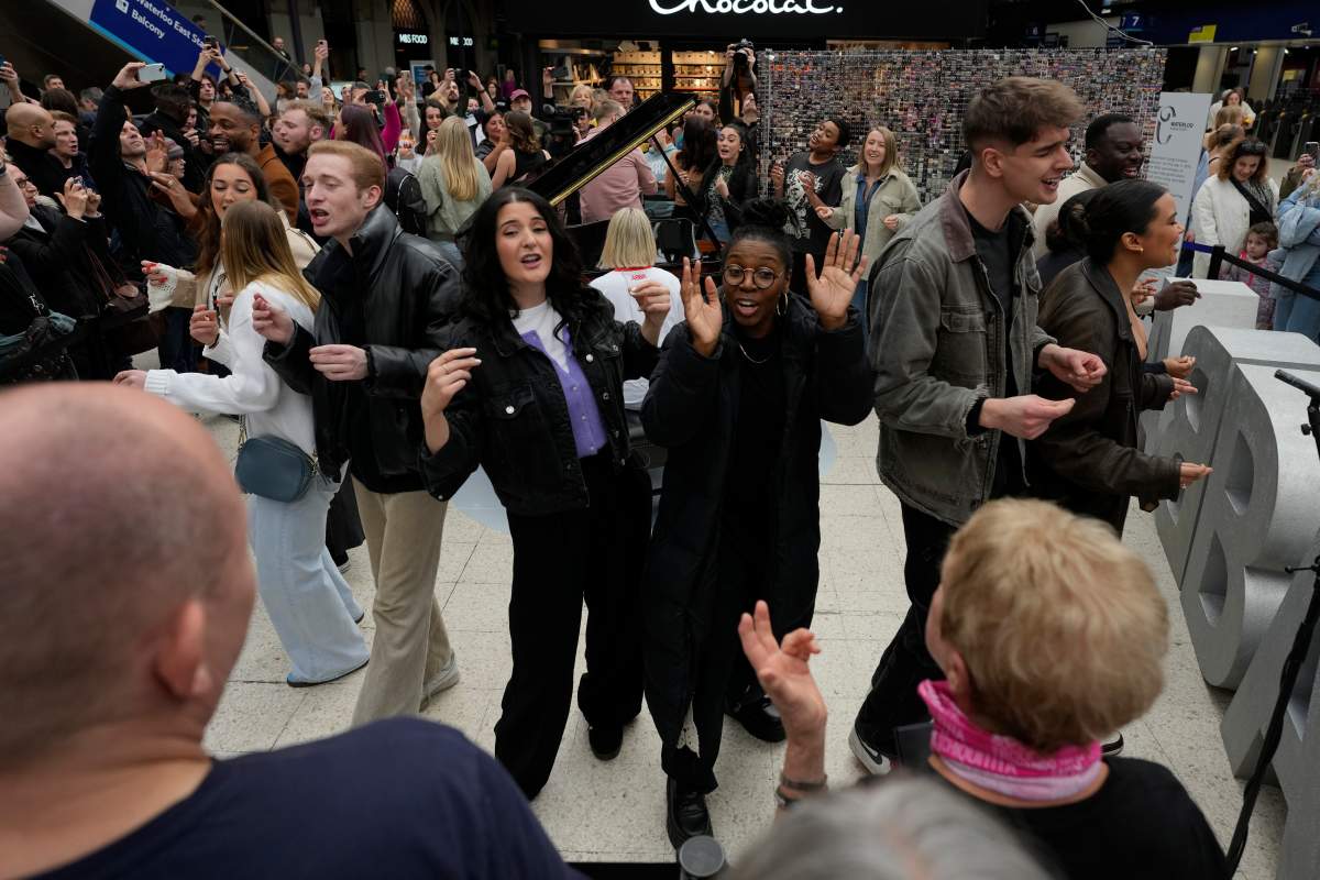 Members of the Mark de Lisser singers preform the iconic ABBA song ‘Waterloo’ at Waterloo Station in London, Saturday, April 6, 2024.