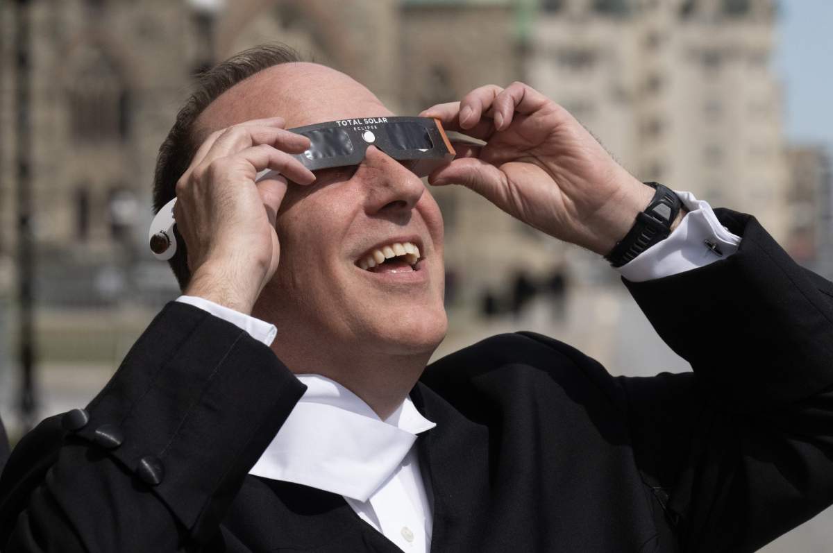 Deputy Speaker of the House Chris d’Entremont tries out a pair of protective glasses outside Parliament, in Ottawa, Monday, April 8, 2024. THE CANADIAN PRESS/Adrian Wyld