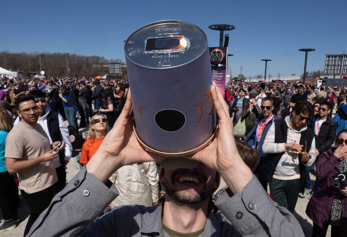 People watch the solar eclipse at Parc Jean Drapeau, in Montreal, Monday, April 8, 2024. CANADIAN PRESS/Ryan Remiorz