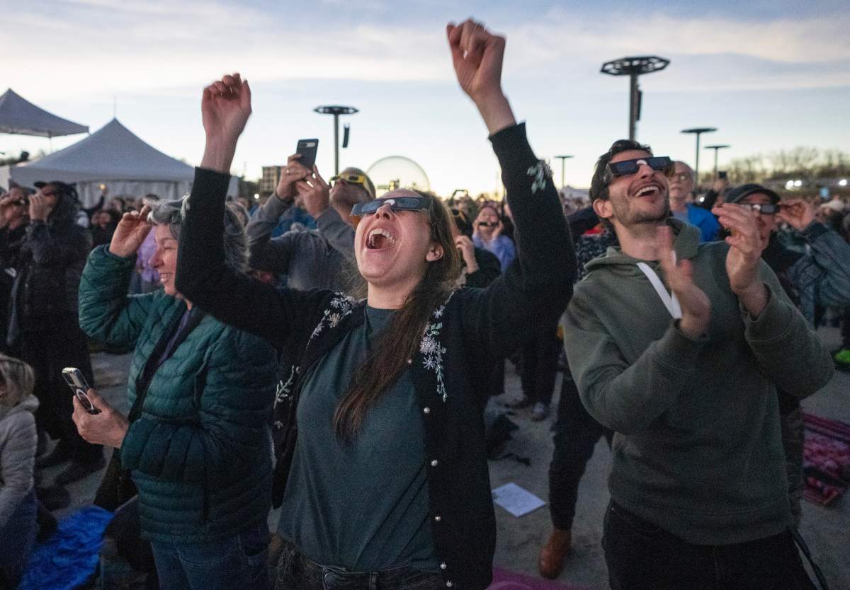 People react to totality occurring during the total solar eclipse at Parc Jean Drapeau, in Montreal, Monday, April 8, 2024. THE CANADIAN PRESS/Ryan Remiorz
