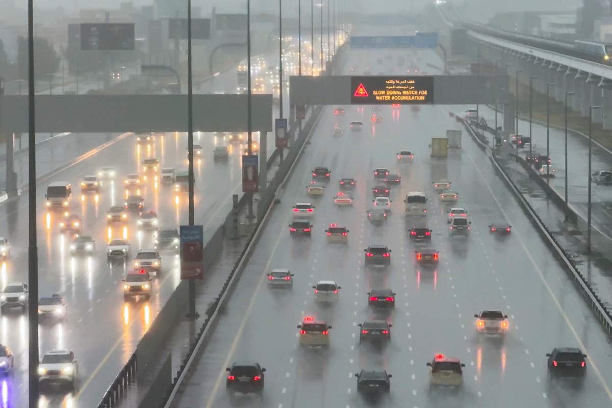 Vehicles drive through heavy rain on the Sheikh Zayed Road highway in Dubai, United Arab Emirates, Tuesday, April 16, 2024. Heavy rains lashed the United Arab Emirates on Tuesday, flooding out portions of major highways and leaving vehicles abandoned on roadways across Dubai. Meanwhile, the death toll in separate heavy flooding in neighboring Oman rose to 18 with others still missing as the sultanate prepared for the storm. (AP Photo/Jon Gambrell)