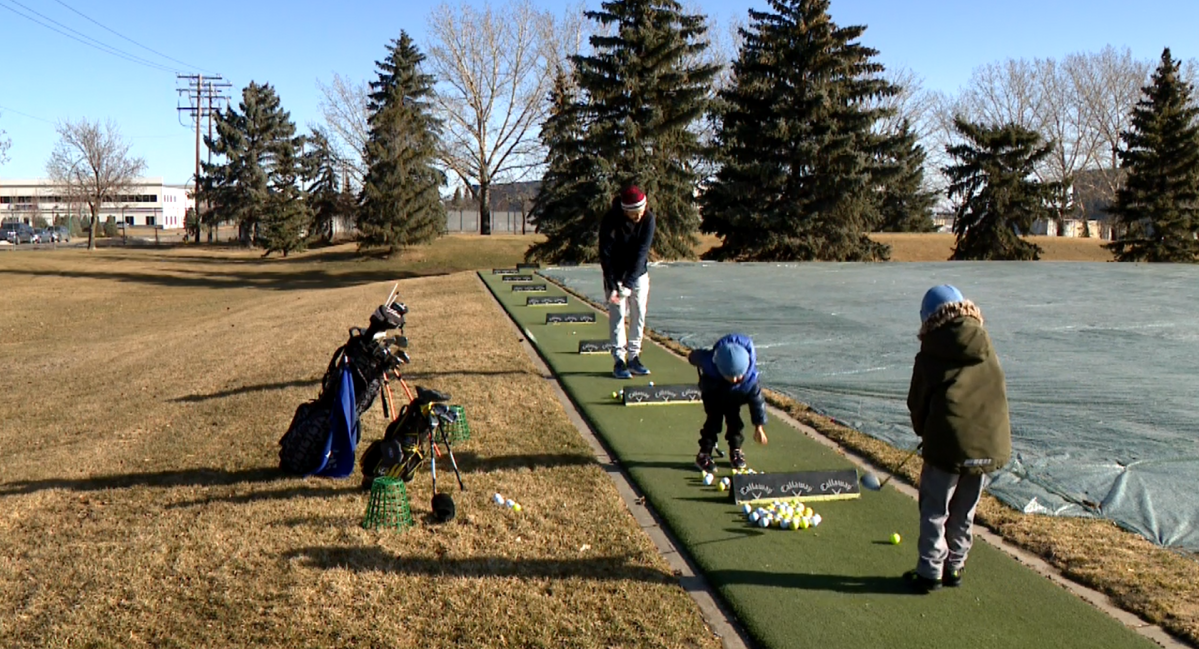 Ryley Mcnuaght and his sons playing golf at the Silverwood Driving Range on April 11, 2024.