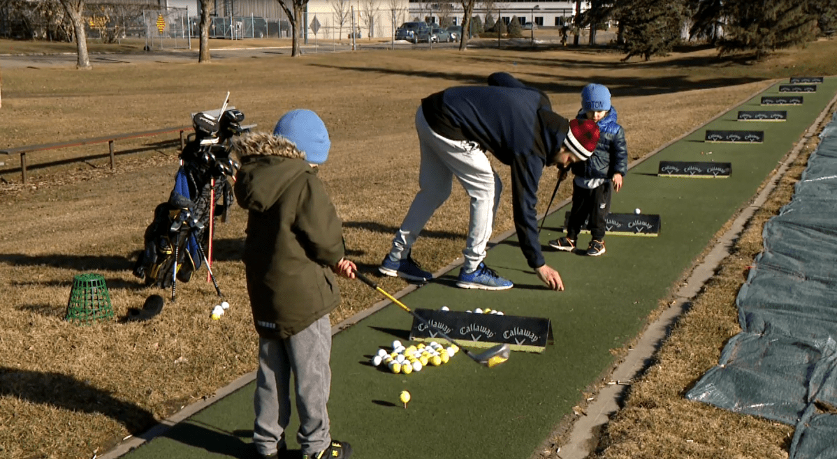 Ryley Mcnuaght and his sons playing golf at the Silverwood Driving Range on April 11, 2024.