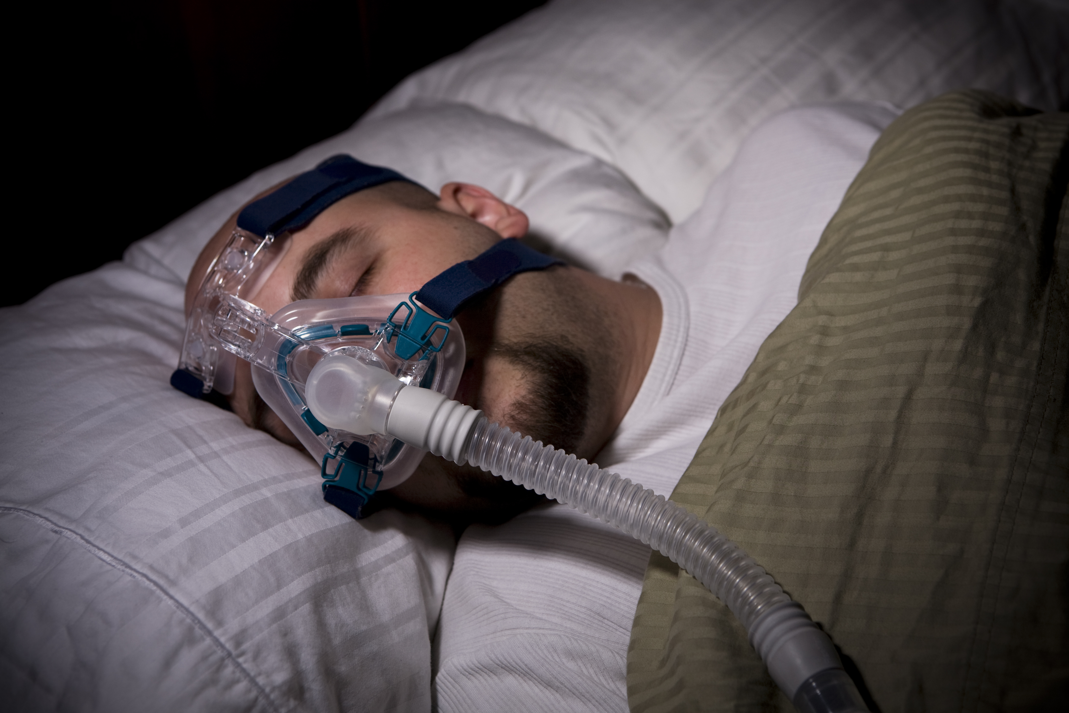 Man sleeping while wearing a CPAP mask for sleep apnea. I've been contacted on several occasions about this photo. I guarantee you this is not a picture of you, you husband, your brother, or anyone else but me! This is a photo of me in my bed, with my sheets, my pillow, and my CPAP mask. Again, this photo is a photo of me taken by me.