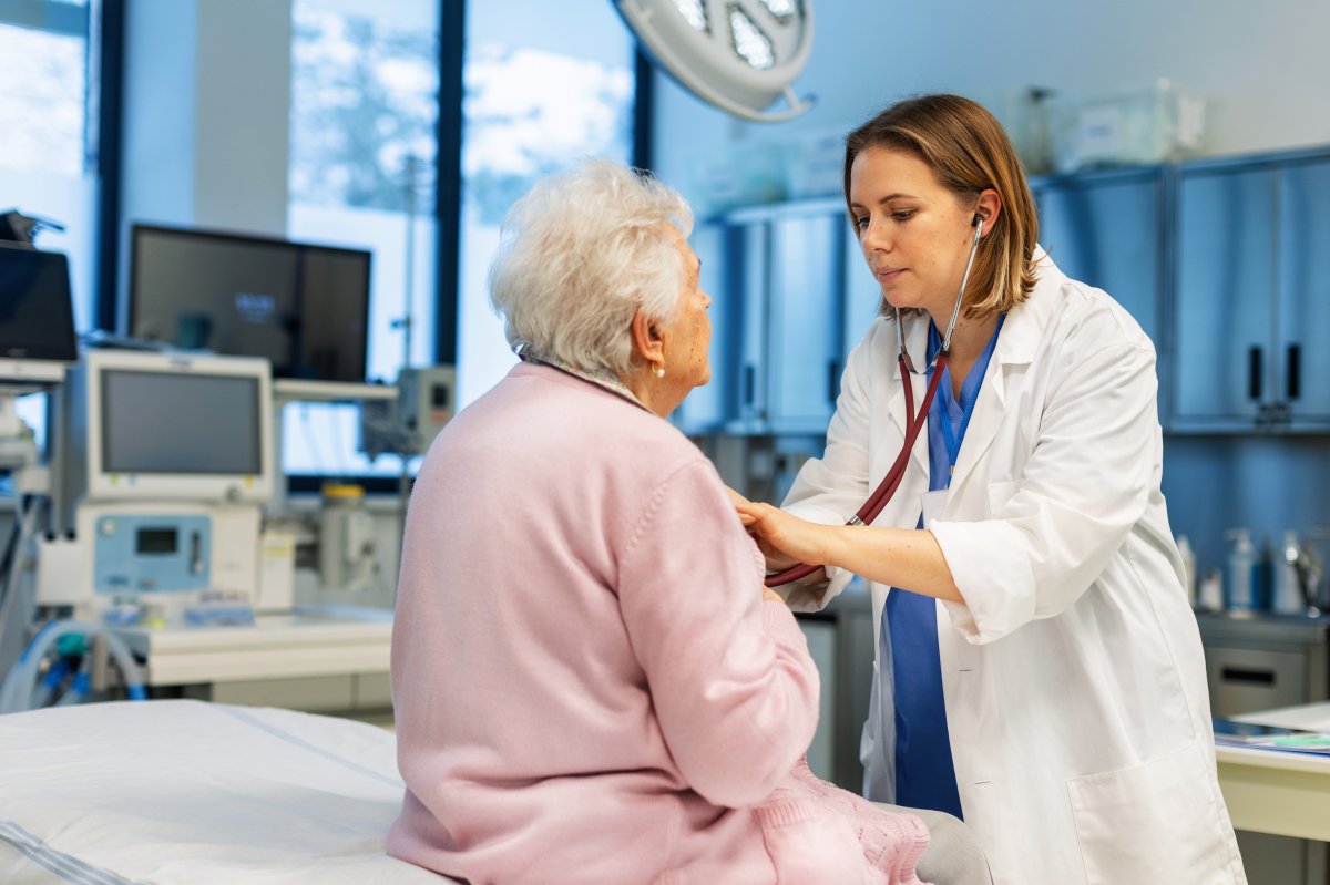 Doctor listening senior woman's breathing, heartbeats using a stethoscope. Elderly patient have problem with breathing, chest pain, heart palpations. Concept of preventive health care for elderly people.