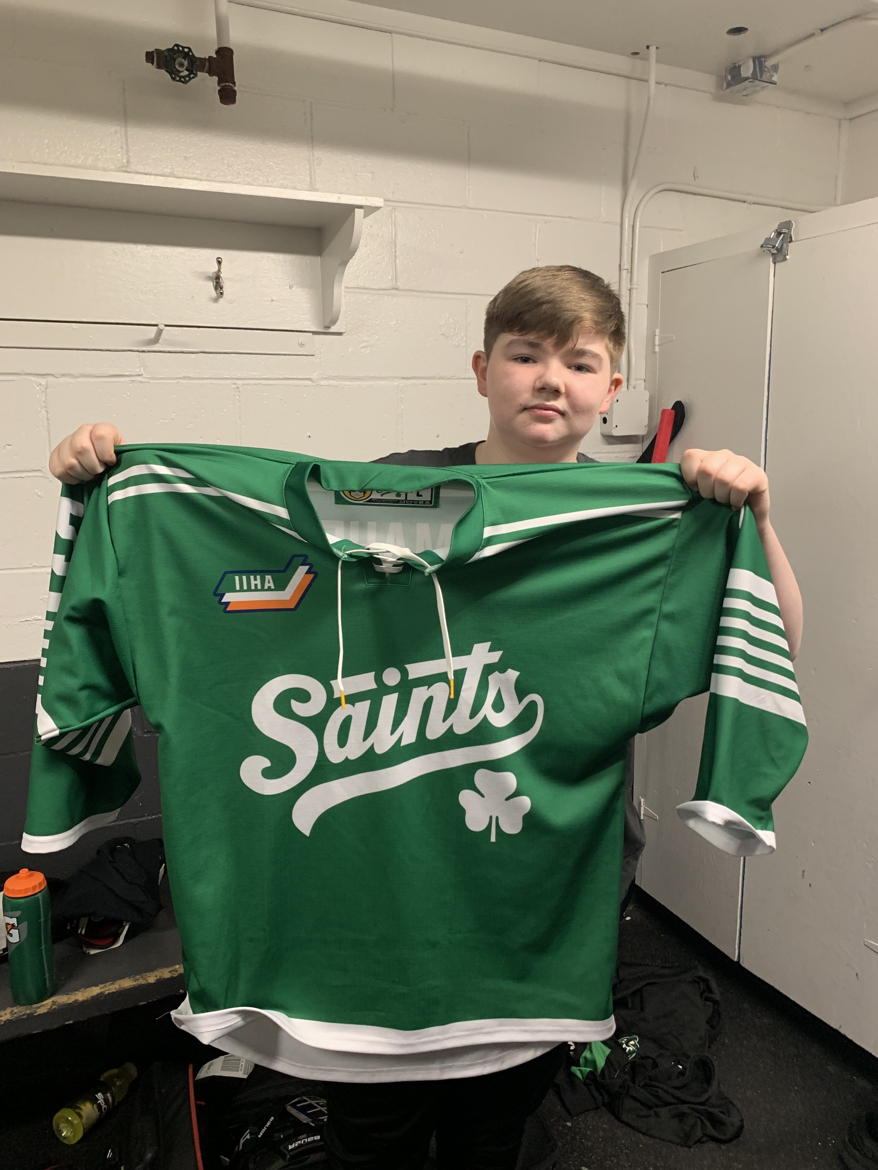 14-year-old Matthew Maher holds up his Saints jersey following his squad’s game on Friday. He said his teammates endured an 18-hour trip from Dublin, Ireland, to participate in the SEDMHA tournament in Nova Scotia.