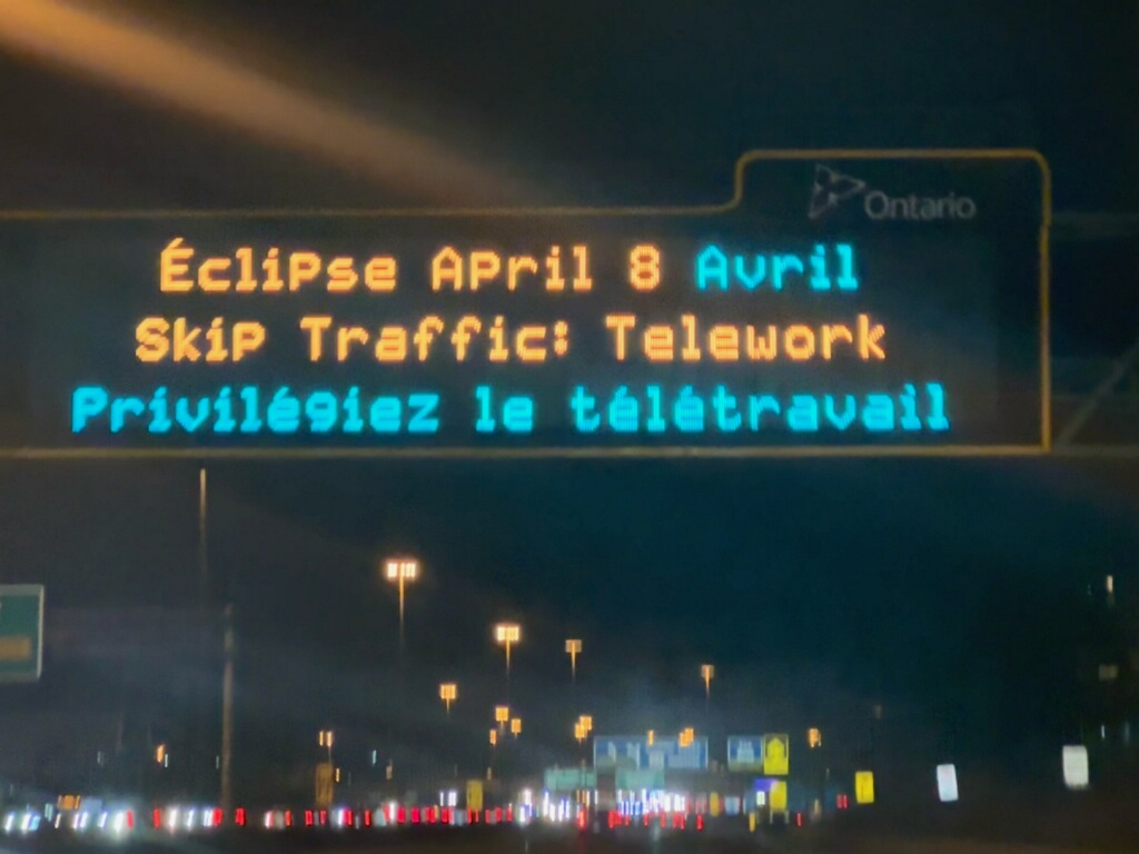 A sign on a Toronto-area highway encouraged people to work from home during the solar eclipse.