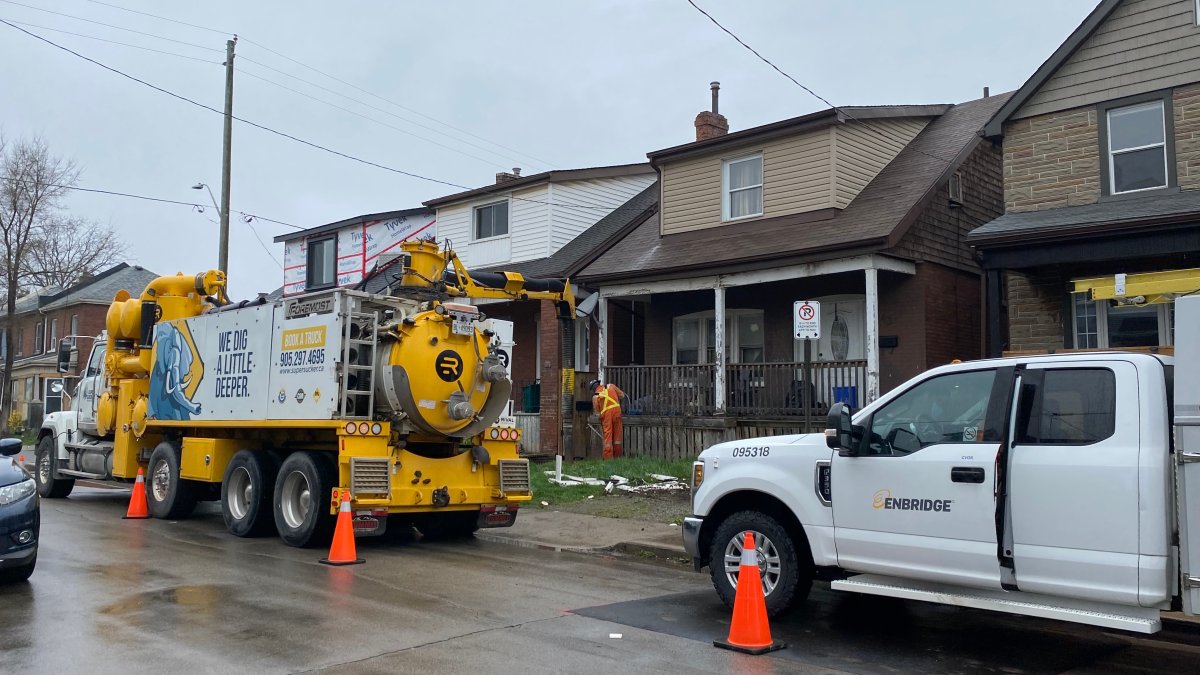 Service crews at a home on Campbell Avenue in Hamilton, Ont. repairing gas line after a car crashed into a house early on Apr. 19, 2024. 