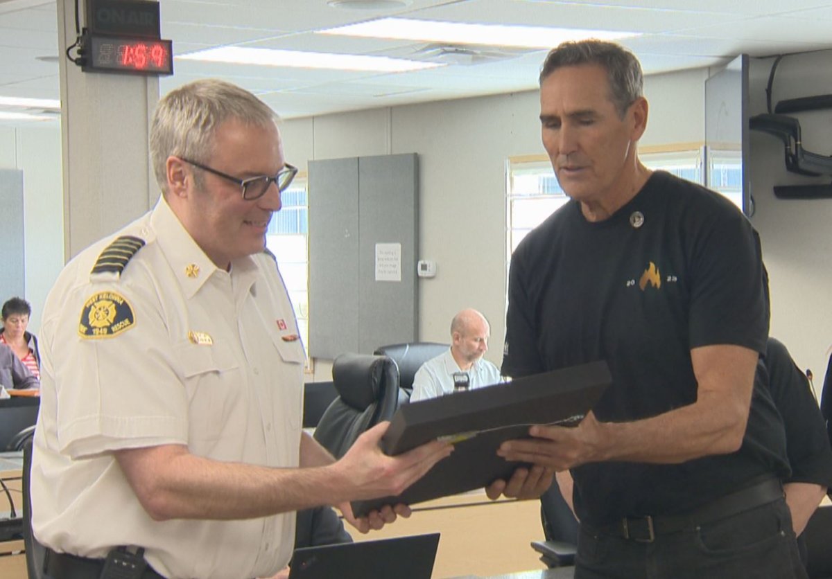 West Kelowna fire chief Jason Brolund, left, received a plaque on Tuesday for his work during last year’s McDougall Creek wildfire.