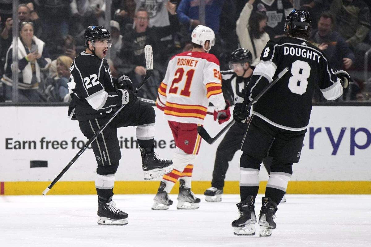 Los Angeles Kings left wing Kevin Fiala, left, celebrates his goal with defenceman Drew Doughty, right, as Calgary Flames centre Kevin Rooney skates away during the first period of an NHL hockey game Thursday, April 11, 2024, in Los Angeles.
