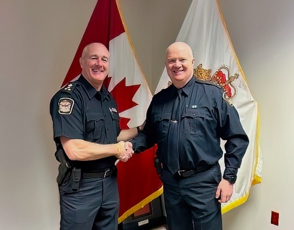 Kawartha Lakes Police Service Chief Mark Mitchell, left, congratulates Insp. Kirk Robertson who has been selected to be the next police chief following Mitchell's retirement this spring.