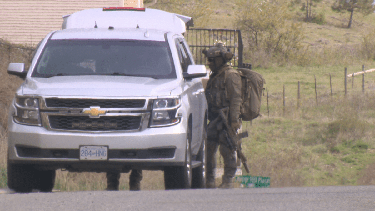 An armed police officer at an incident in Lake Country, B.C., on Tuesday afternoon.