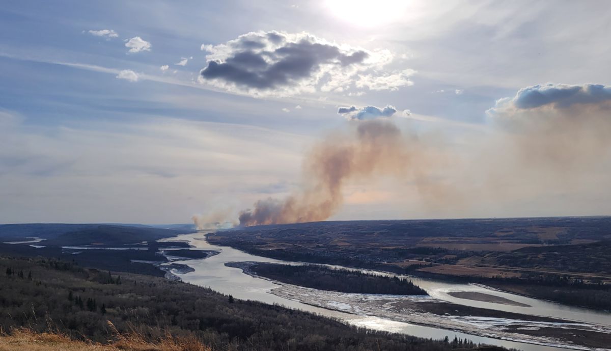A picture of a wildfire burning in northwestern Alberta in April 2024 near the Peace River. Photo is taken from the Sagitawa Lookout.
