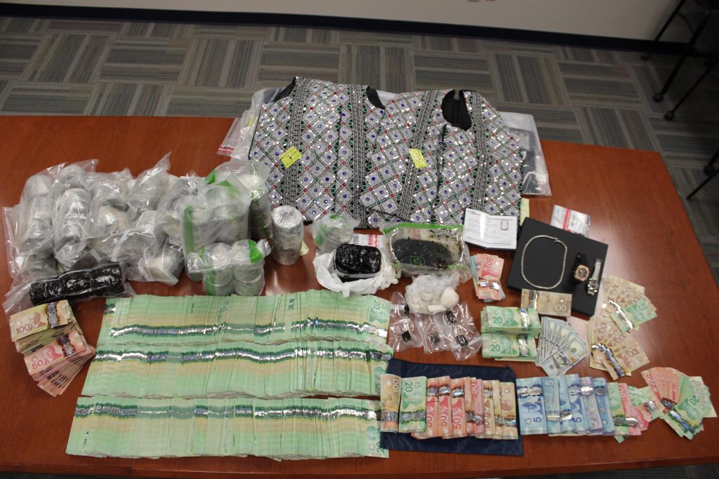 Investigators have arrested and charged nine individuals with numerous criminal offences and seized a large amount of Canadian currency, drugs, and a firearm.