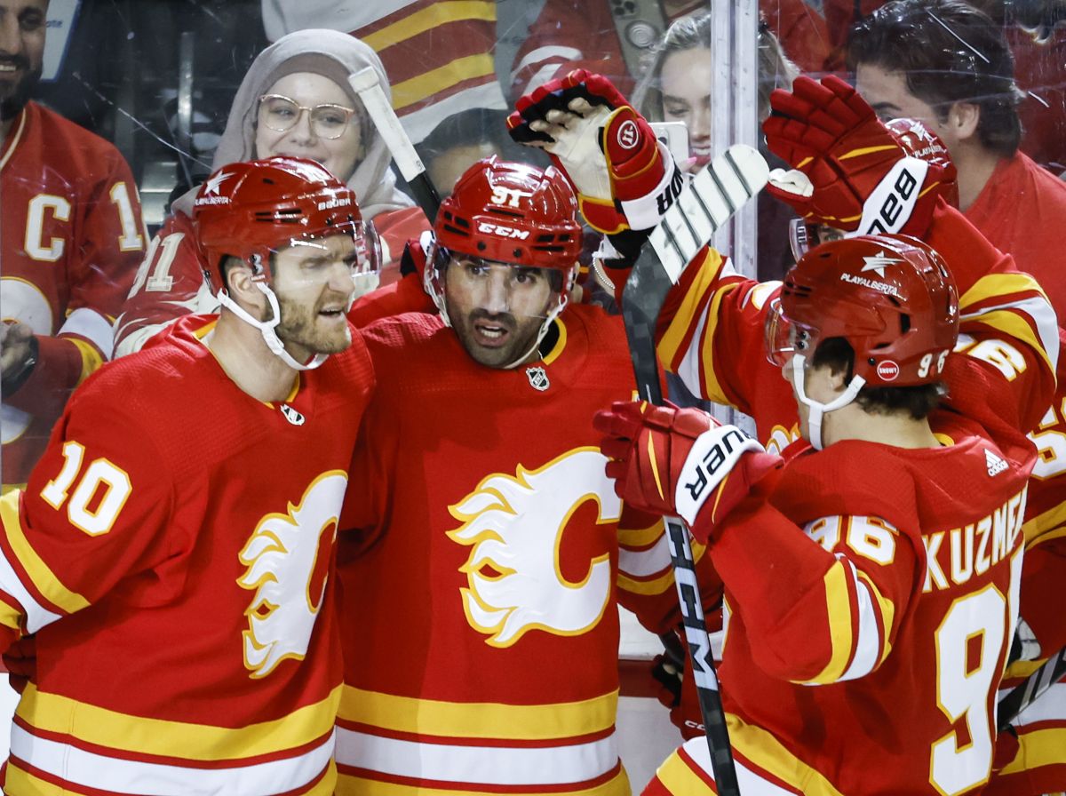 Calgary Flames forward Nazem Kadri (91) celebrates his goal with teammates during third period NHL hockey action against the Arizona Coyotes in Calgary, Alta., Sunday, April 14, 2024.