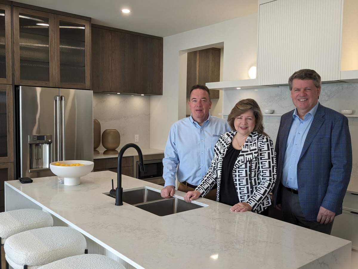 Hospital officials Scott Fortnum, Michelle Campbell, and John H. MacFarlane (left to right) are seen inside the Dream Lottery home April 4, 2024.