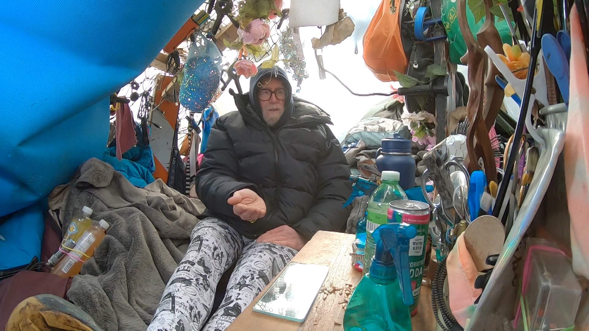 Christenson Bailey feeds birds inside his tent in Vancouver's Stanley Park.