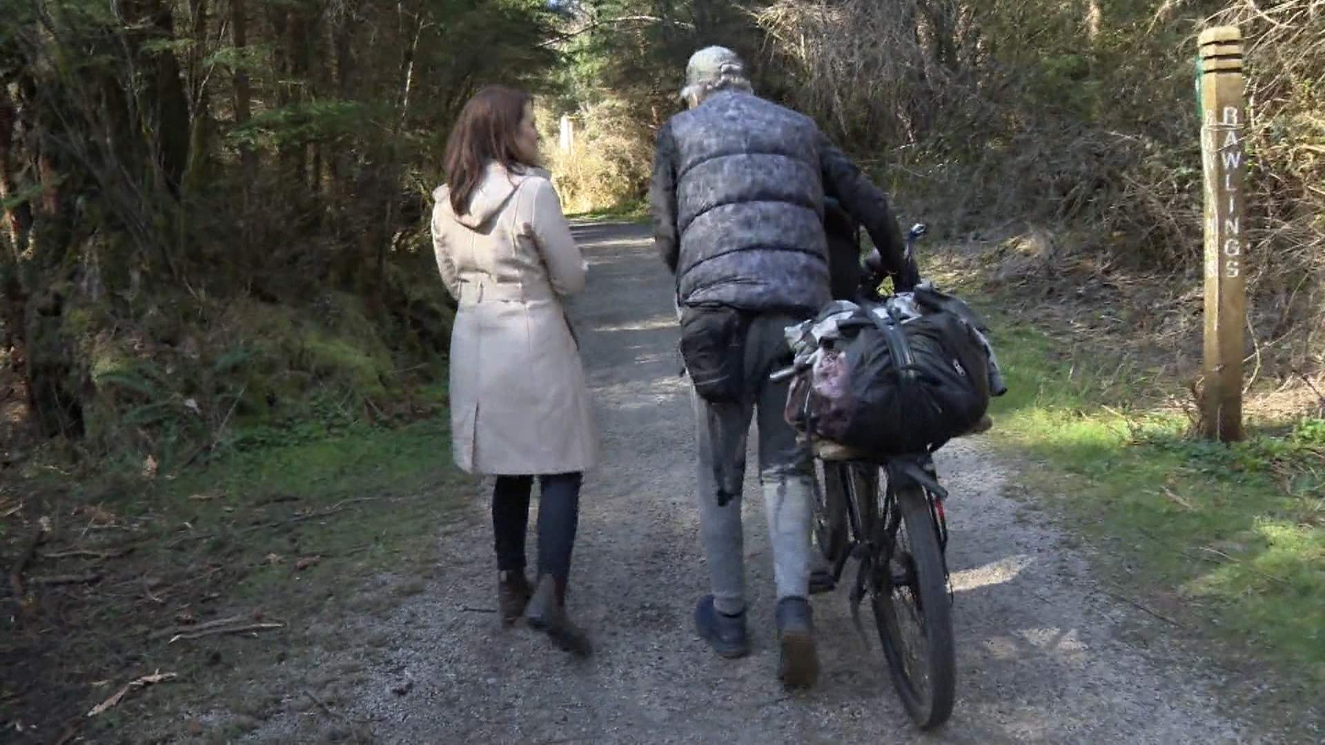 Christenson Bailey and Global News reporter Alissa Thibault walk in Vancouver's Stanley Park.