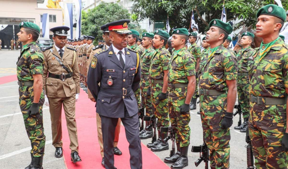 Peel Regional Police Chief Nishan Duraiappah stands next to Sri Lankan soldiers.