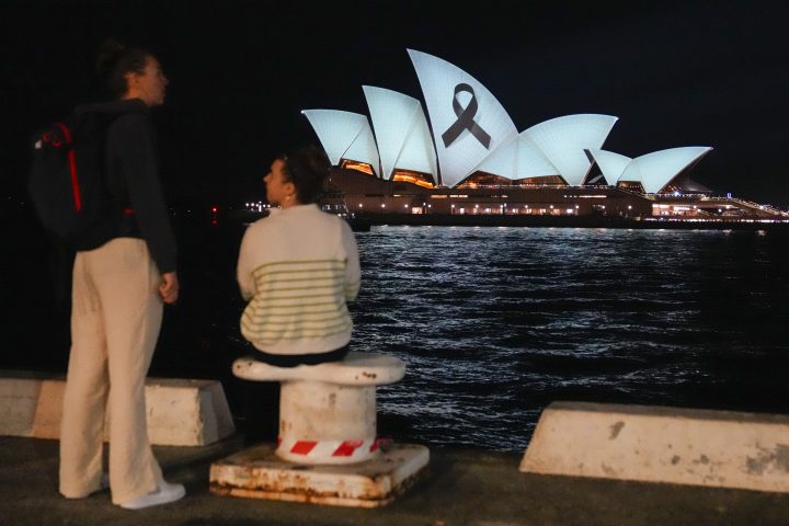 People look as the Sydney Opera House illuminated with a black ribbon on Monday, April 15, 2024, as part of the national day of mourning following a deadly stabbing attack at a shopping mall.