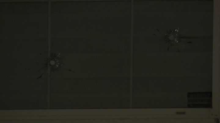 Bulletholes are seen in the window of a home in Calgary's Taradale neighbourhood on April 15, 2024.