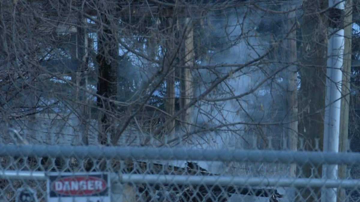 Smoke rises from the remains of a large garage destroyed by an early morning fire just west of Calgary.
