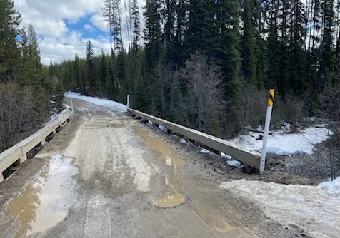 A man and his son were travelling along the 201 Forest Service Road towards Big White on Saturday when they spotted a body in a creek.