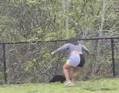 The woman chases the scared bear after dropping it.