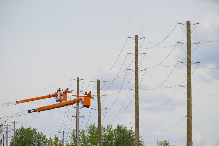 Hydro Crews work to fix broken power poles and restore power in the Ottawa Valley municipality of Mississippi Mills, Ontario on Tuesday, May 24, 2022. A major storm hit parts of Ontario and Quebec on Saturday. 