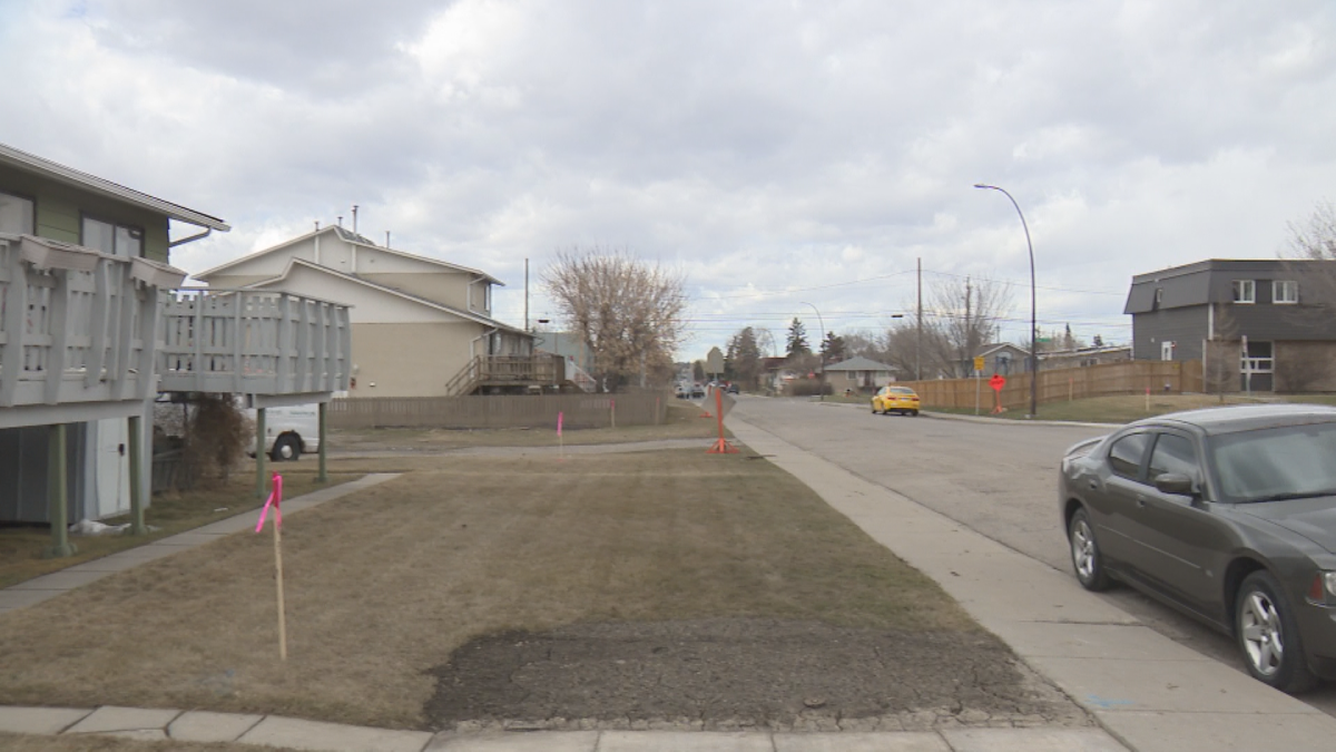 Newly placed stakes to show the placement of the newly configured 78 Avenue S.E.