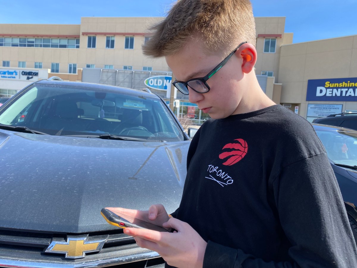 Calgary student Parker Froese with cellphone