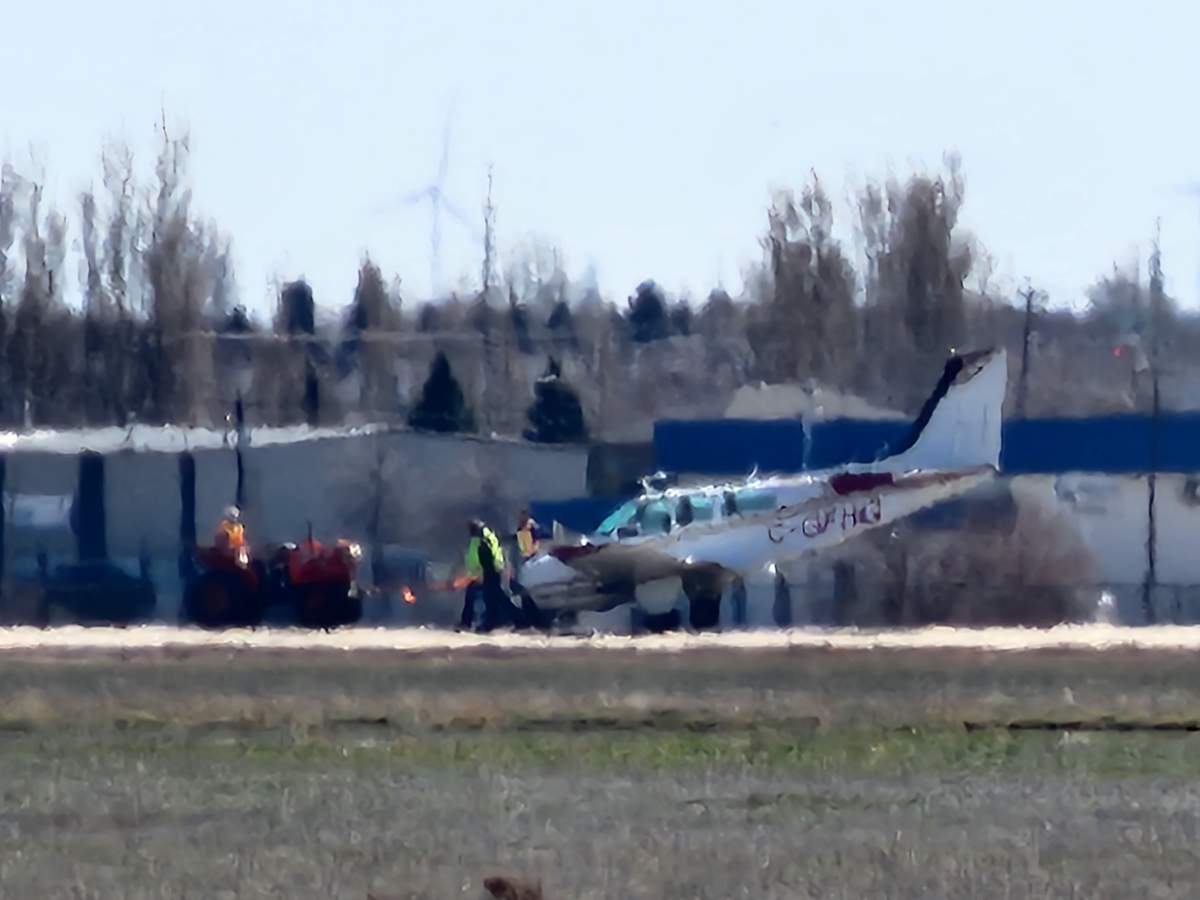 A small plane is shown being towed away after it was forced to make an emergency landing at the Medicine Hat Airport on April 11, 2024.