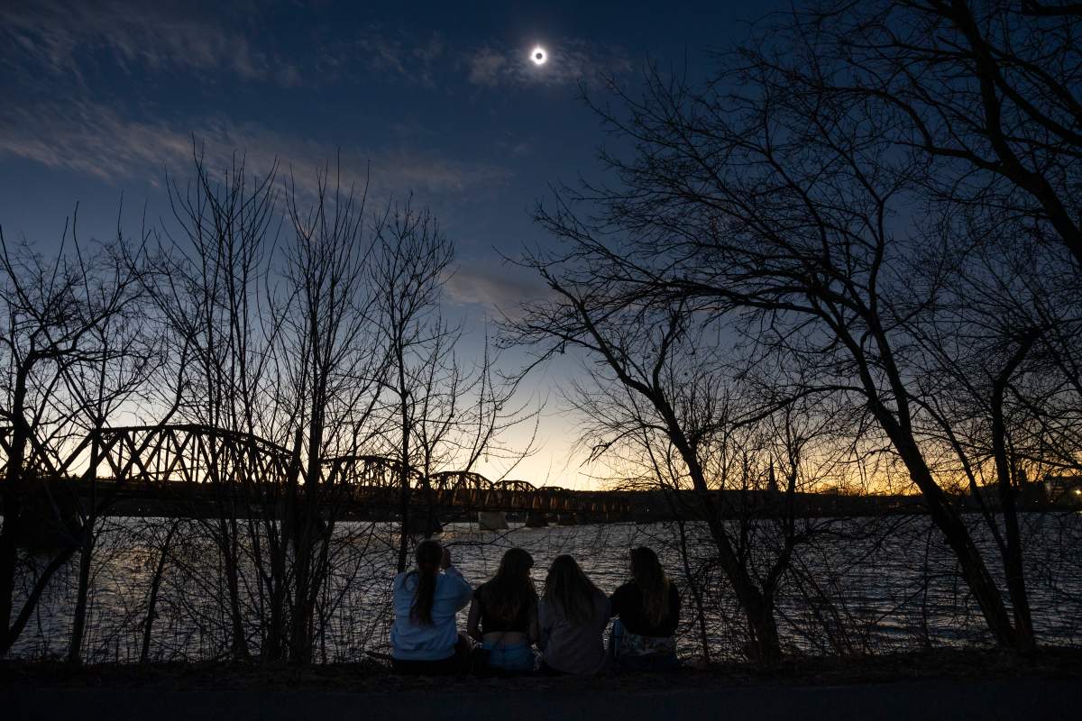 Skywatchers are silhouetted during totality of the total solar eclipse in Fredericton on Monday. THE CANADIAN PRESS/Darren Calabrese
