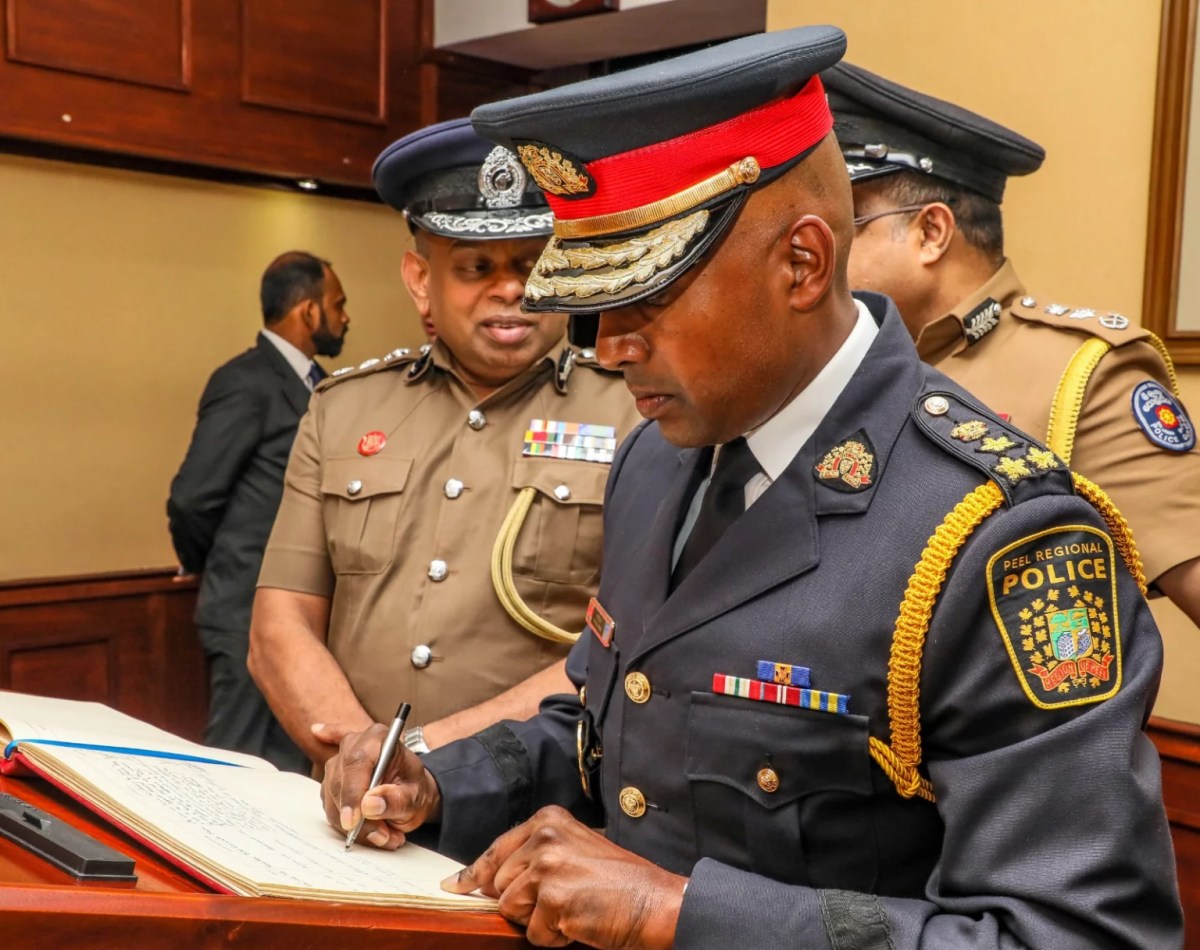 Peel Regional Police Chief Nishan Duraiappah signs a guestbook.