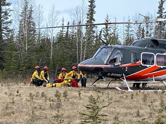 Wildland firefighting recruits learn how to safely get in and out of a helicopter.