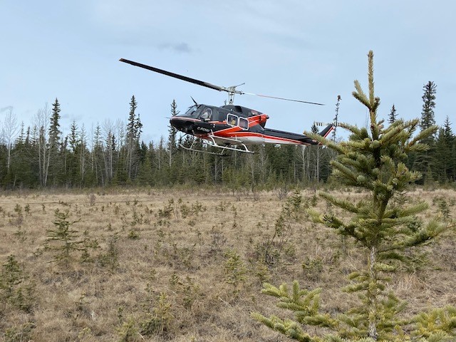 Wildland firefighting recruits learn how to safely get in and out of a helicopter.