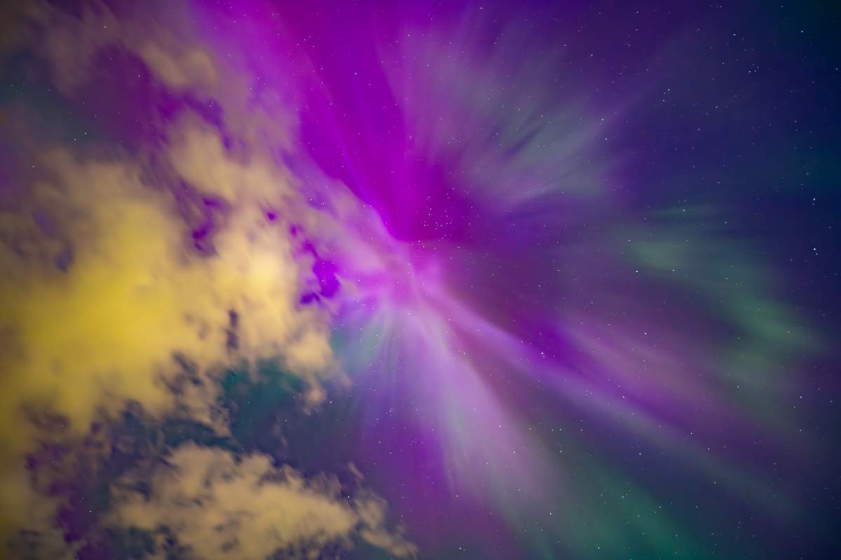 Purple and blue northern lights in the sky at Sunset Point Beach in Collingwood, Ont. on the night of May 10, 2024