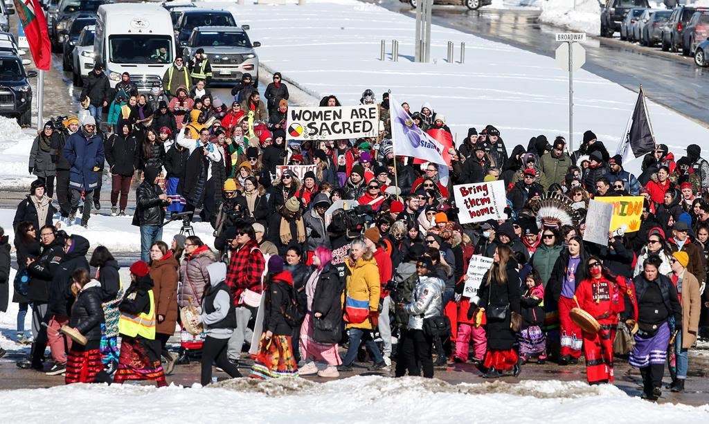 Family and supporters walk from Portage and Main to the Manitoba legislature to protest the provincial government's delay in searching a landfill for missing indigenous women, Friday, March 8, 2024. 
