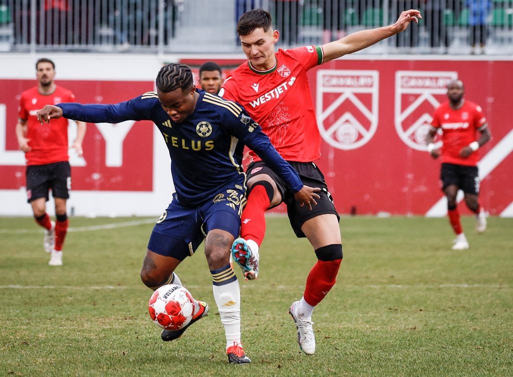 FILE Vancouver Whitecaps FC defender Javain Brown (left) controls the ball as Cavalry FC attacker Lleyton Brooks checks during first half soccer action in the Canadian Championship quarterfinal, leg 1, in Calgary, Tuesday, May 7, 2024. 