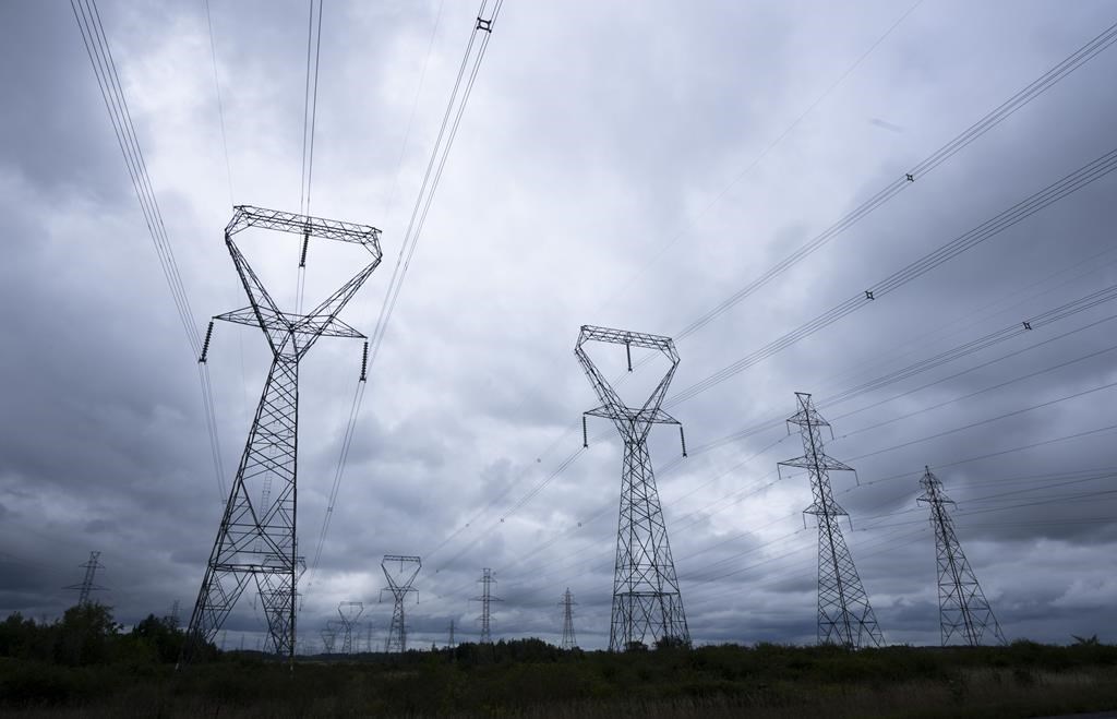 Power lines are seen against cloudy skies near Kingston, Ont. on Wednesday, Sept. 7, 2022 in Ottawa. THE CANADIAN PRESS/Adrian Wyld.