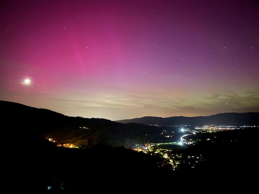 Northern lights appear over the Dreisamtal valley in the Black Forest near Freiburg, Germany, Friday evening, May 10, 2024.