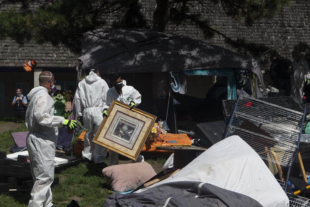 A new report is proposing that Toronto move to clear homeless encampments only as a "last resort," and with at least 72 hours of notice. City workers clear encampment residents' belongings after Toronto Police cleared the Lamport Stadium Park homeless encampment in Toronto on Wednesday, July 21, 2021. 