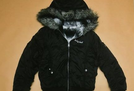 An evidence photo of a Baby Phat branded jacket is shown at a news conference for an ongoing homicide investigation in Winnipeg, Thursday, Dec. 1, 2022. 