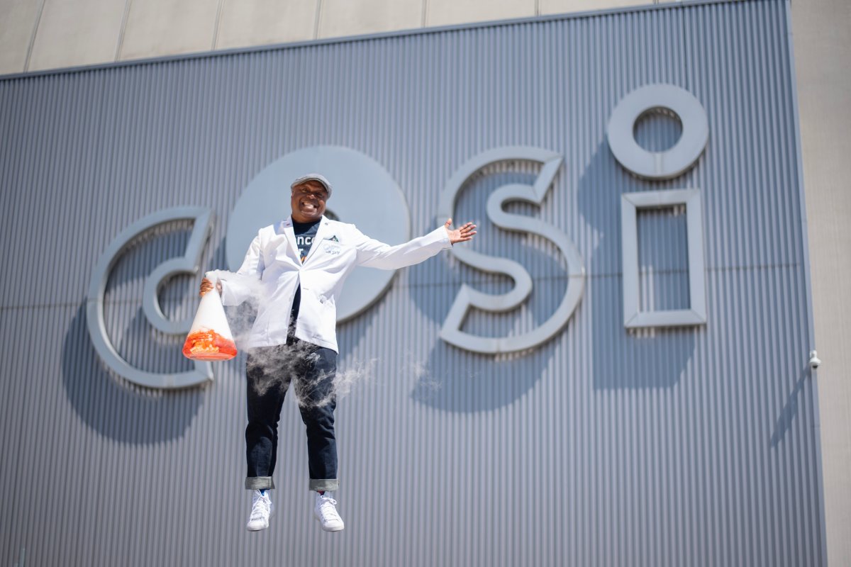 Dr. Bertley in front of the COSI Museum's sign in Columbus, Ohio. 