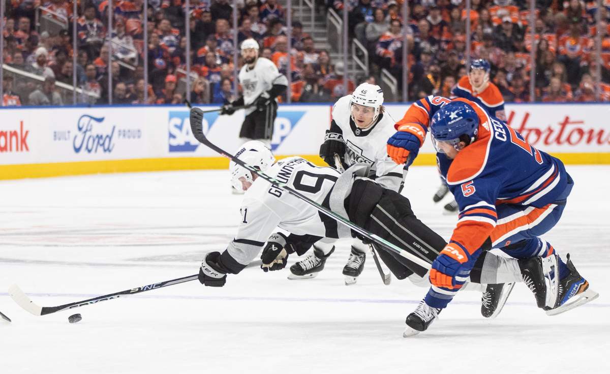 Los Angeles Kings' Carl Grundstrom (91) collides with Edmonton Oilers' Cody Ceci (5) during first period NHL playoff action in Edmonton on Wednesday May 1, 2024.